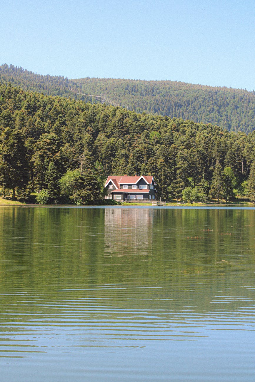 Waterfront cottage on a calm Ontario lake at golden hour — Muskoka cottage country 2026